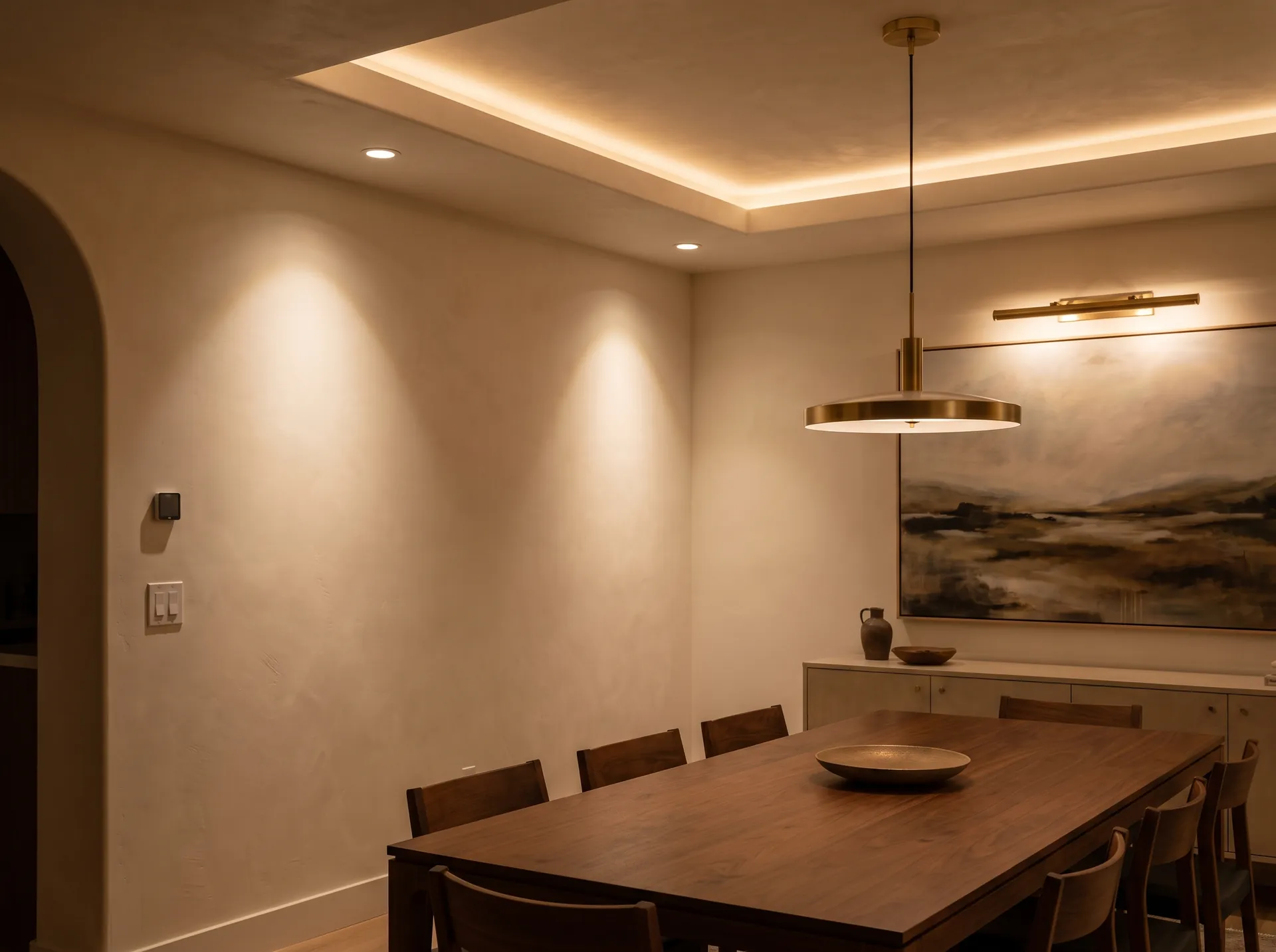 Dining room with cove lighting and brass picture light, an electrical and lighting installation.