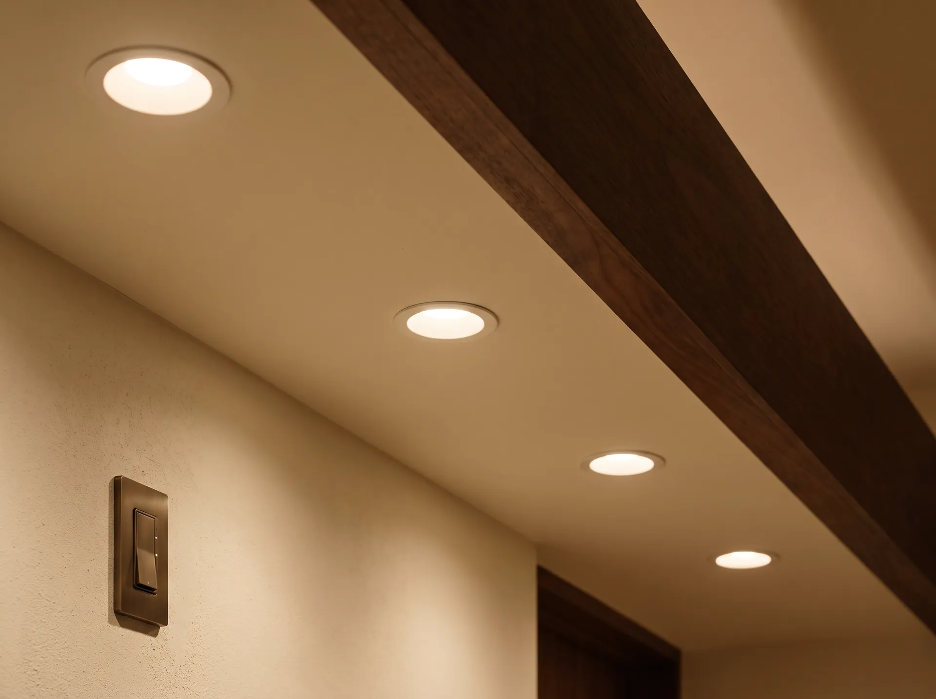 Recessed lighting and pendant light installed in a finished ceiling.